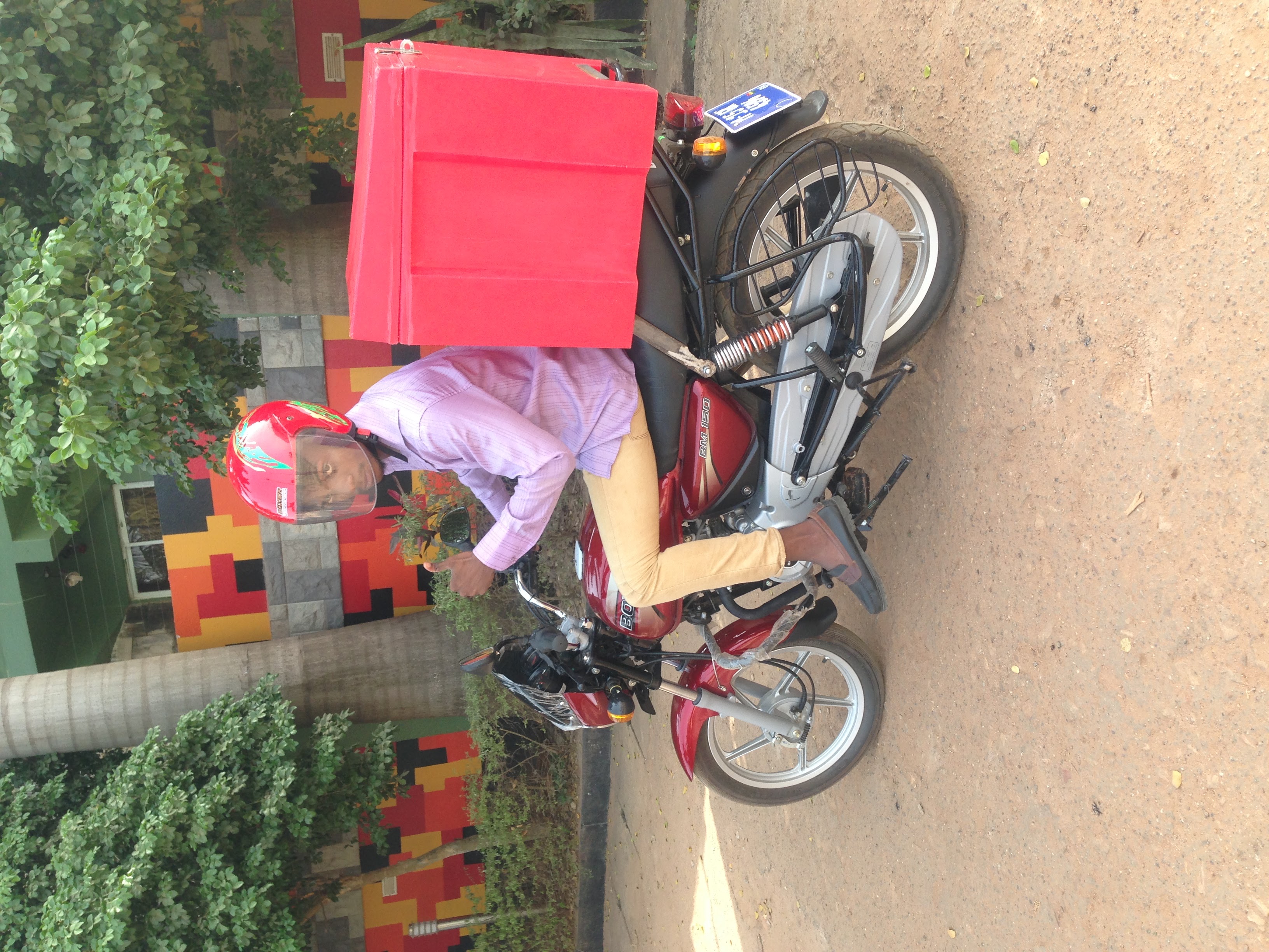 Samora Dake on a delivery motorcycle
